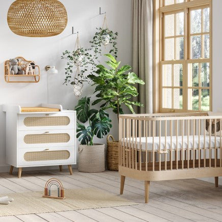 Wooden scandi baby furniture in a nursery